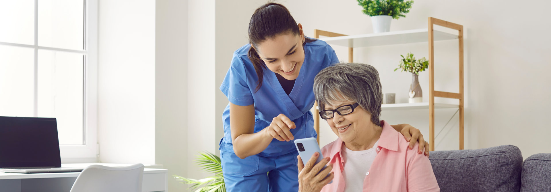 woman and senior looking in phone