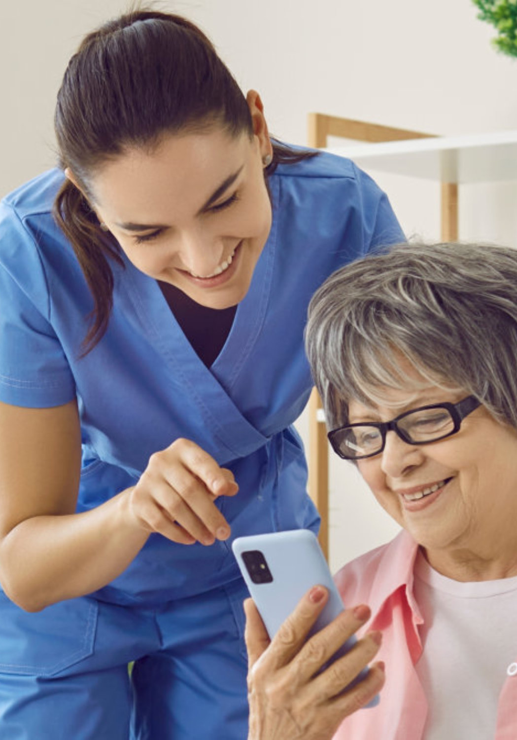 woman and senior looking in phone