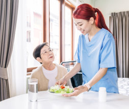 woman giving foot to senior