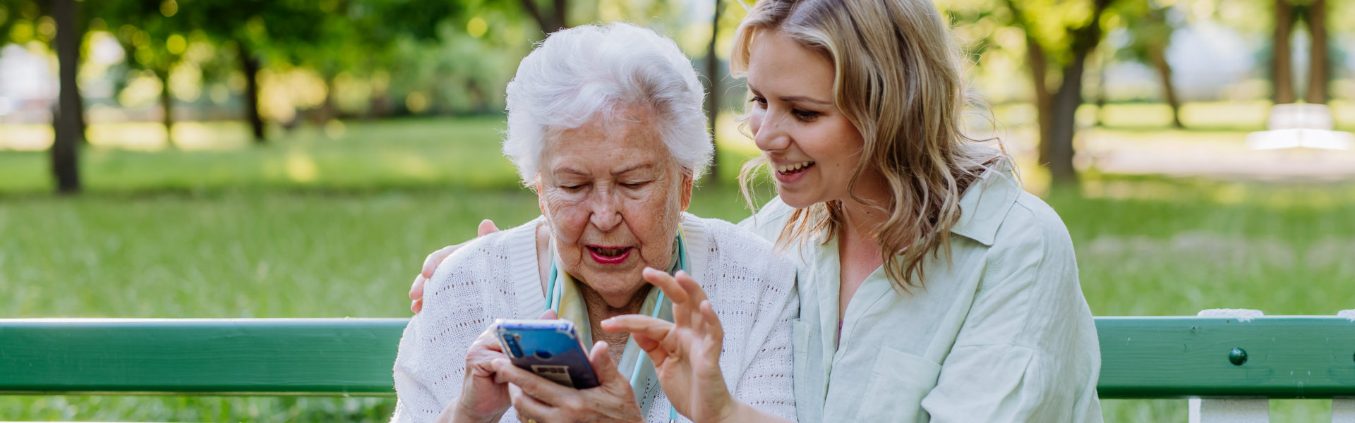 senior holding a phone with woman