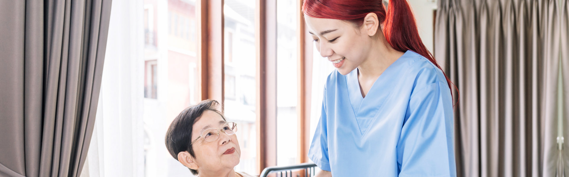 woman giving food to senior